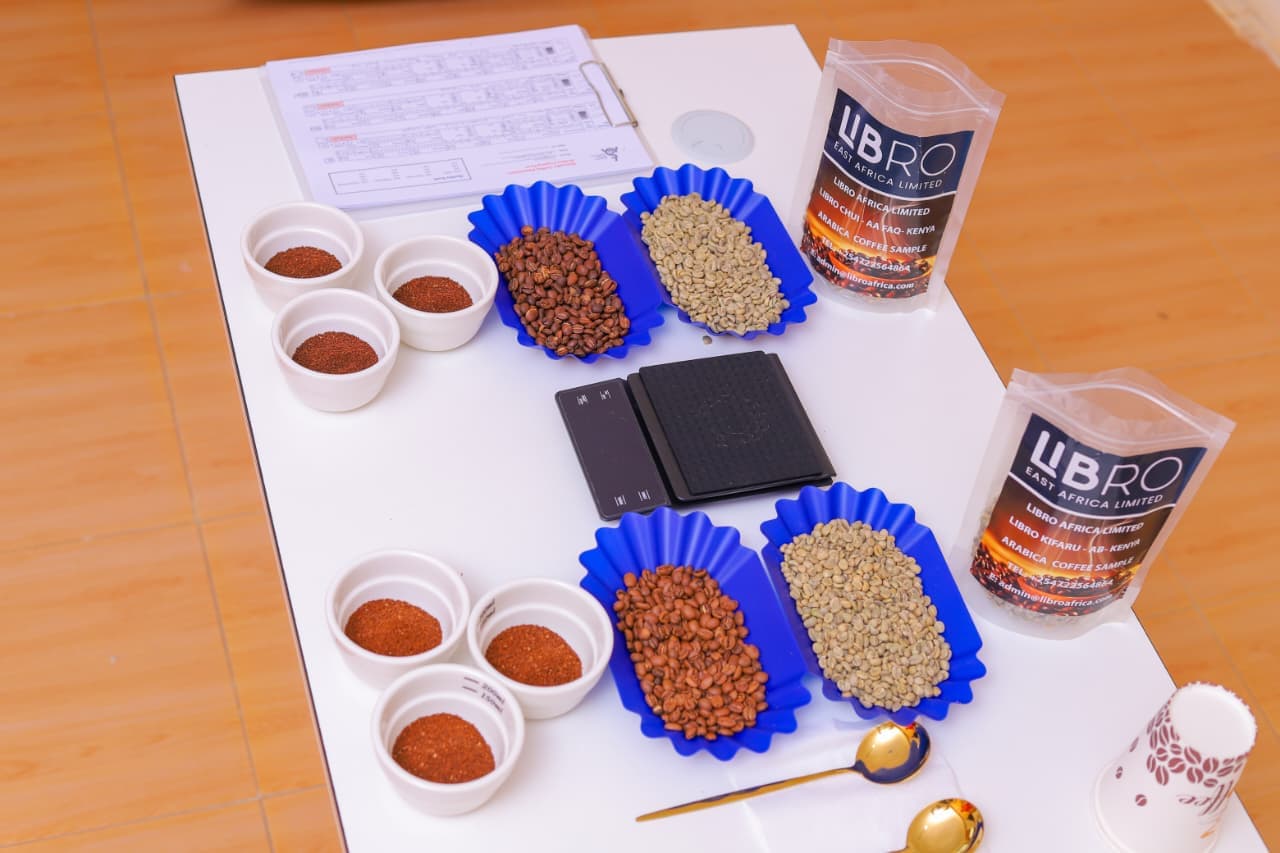 Libro East Africa sample bags labeled FAQ AA and AB grade Kenyan Arabica with cupping equipment