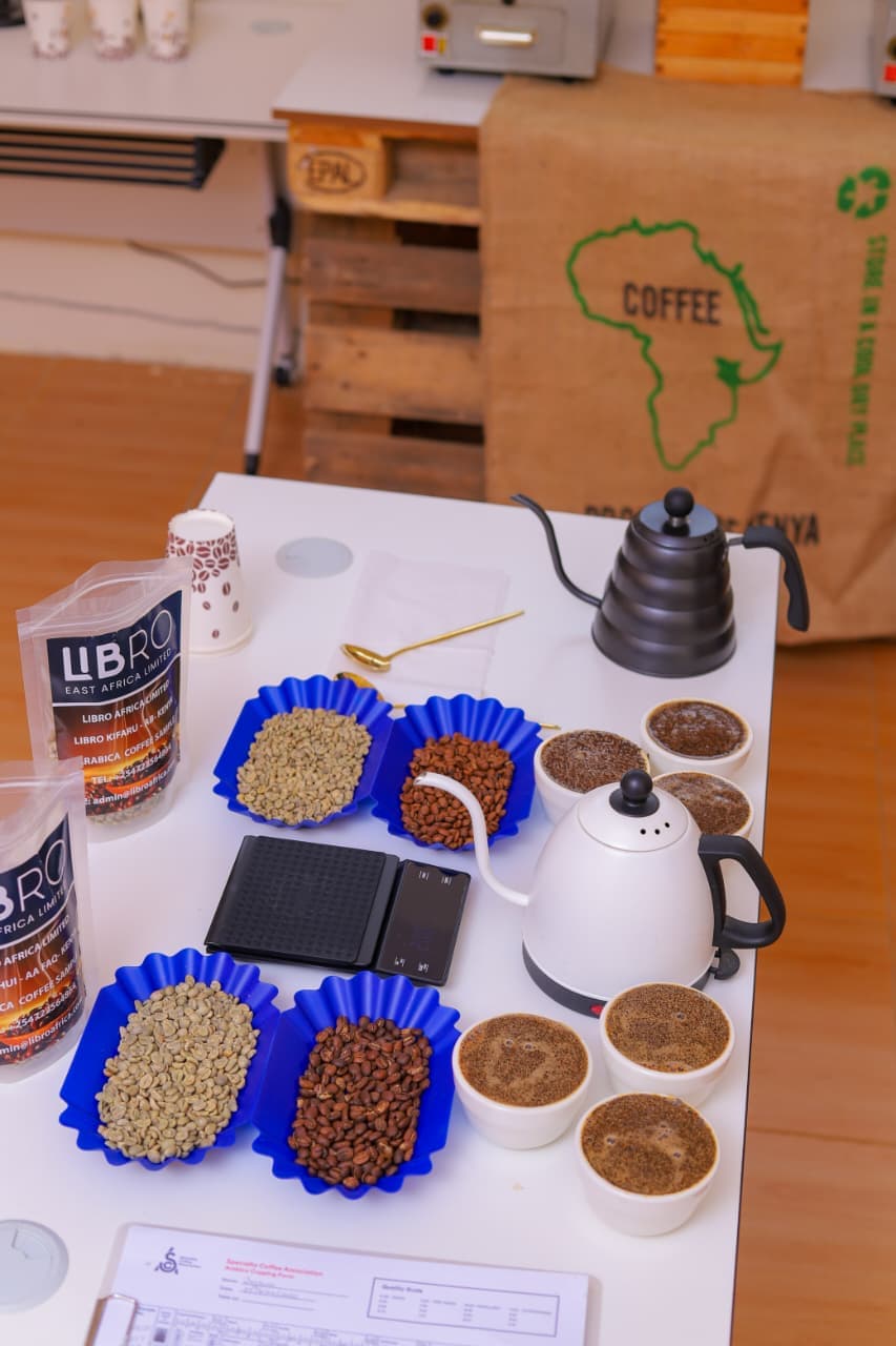 Libro East Africa cupping lab with green and roasted coffee samples, pour-over kettles and SCA cupping forms